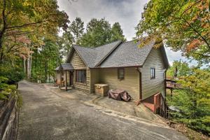 a small green house with a driveway at Home with Spacious Deck, BBQ, Game Room and Lake Views in Hiawassee