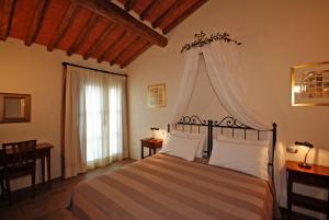 a bedroom with a bed with a canopy at Molino Di Foci in San Gimignano +57 photos