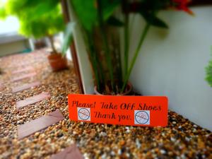 a sign that says punch take off shoes thank you at Neptune's Villa in Haad Rin