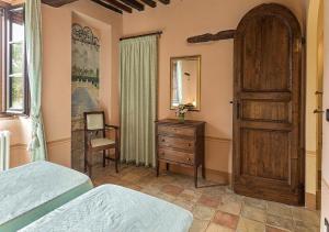 a bedroom with two beds and a dresser and a door at Villa Giulia in Tuoro sul Trasimeno