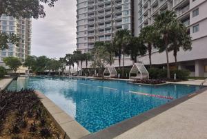 a large swimming pool in a city with tall buildings at Teega Suites Puteri Harbour #Seaview Unit in Nusajaya