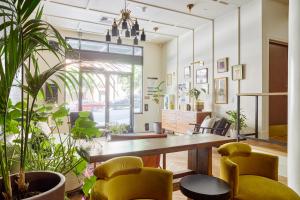 a living room filled with tables and chairs at Sonder at FOUND Union Square in San Francisco