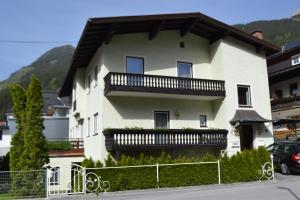 a white house with a balcony on the side of it at Apartment Marianne in Bad Gastein