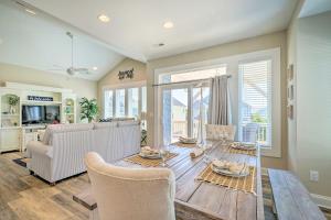 a living room with a table and a couch at Surf City House about 400 Ft Walk to Beach with Decks! in Surf City