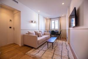 a living room with a couch and a table at Vignature residence in Asnières-sur-Seine