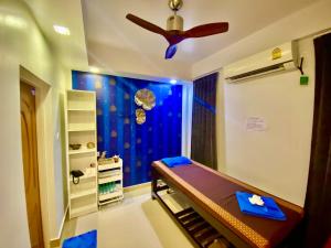 a bedroom with a bed and a ceiling fan at Beach Breeze and Spa in Hulhumale