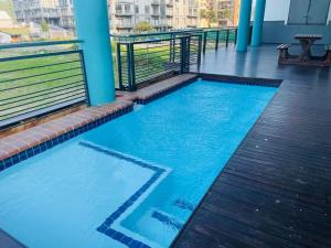 a swimming pool on the roof of a building at The Waves, 302 Quayside Point Waterfront in Durban