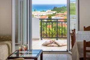 a living room with a view of the ocean at Yiannis Studios in Tsilivi