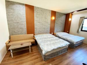 a bedroom with a bed and a desk at Saint Malo Homestay in Lugu Lake
