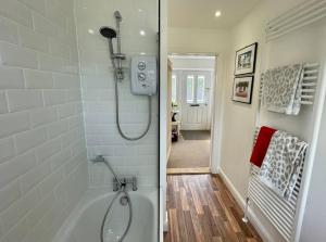 a bathroom with a shower with a glass door at Stylish Boutique Bungalow in Felixstowe