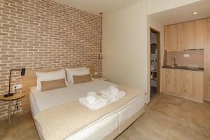 a bedroom with a bed with towels on it at The Archontariki in Ormos Panagias