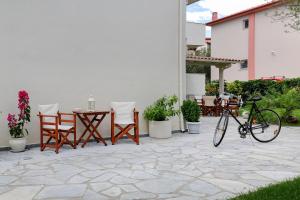 a bike parked on a patio with a table and chairs at The Archontariki in Ormos Panagias