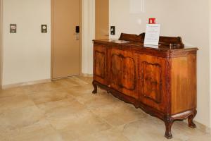 a wooden dresser with a sign on it in a room at The Archontariki in Ormos Panagias