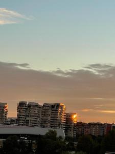 a city skyline with tall buildings at sunset at On the top floor watching CityLife and MiCo in Milan