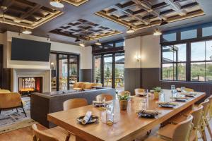 a dining room with a long table and a fireplace at The Eddy Taproom & Hotel in Golden