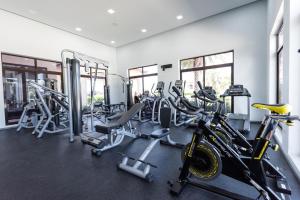 a gym with several treadmills and cardio machines at Diamante 181 Luxury home in Gold Coast 4 Bedrooms 3 Bath in Palm-Eagle Beach
