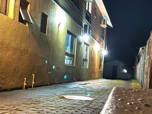 an empty street at night with a building at Hotel San Martin in Cabrero