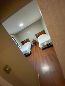 an overhead view of a bedroom with two beds at Hotel San Martin in Cabrero