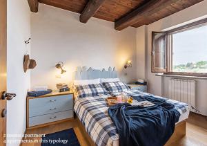 A bed or beds in a room at Borgo Solario