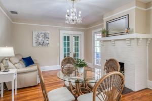 a living room with a glass table and chairs and a fireplace at 16 Saragossa Street B in St. Augustine +36 photos