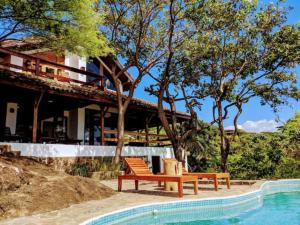 a resort with two benches next to a swimming pool at Shankton Tower in El Gigante