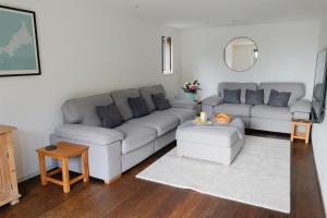 a living room with a couch and a table at No.10 Falmouth - 2 minutes walk to the beach in Falmouth