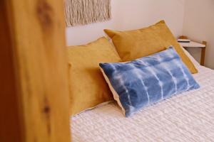 a bed with a blue pillow on top of it at CHIVILCOY APART in Chivilcoy