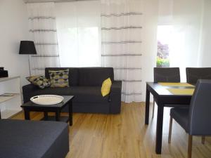 ein Wohnzimmer mit einem Sofa und einem Tisch in der Unterkunft Ferienwohnung Litterscheid in Kiefersfelden