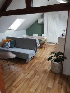 a living room with a couch and a table at La Plage in Fécamp