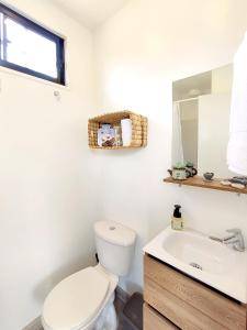 a bathroom with a toilet and a sink at Libre Camp Amarillo in Nemocón
