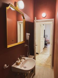a bathroom with a sink and a mirror at Residenza Studio delle Arti in Bologna