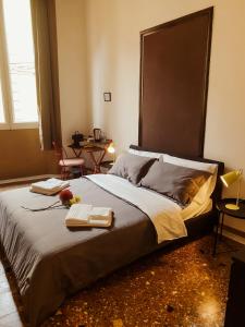 a bedroom with a large bed with two towels on it at Residenza Studio delle Arti in Bologna