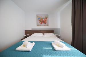 Postel nebo postele na pokoji v ubytování Apartmani Diklo