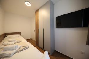Postel nebo postele na pokoji v ubytování Apartmani Diklo