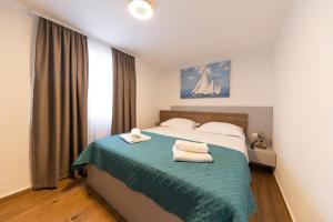 Postel nebo postele na pokoji v ubytování Apartmani Diklo