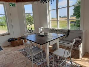 a dining room with a table and chairs at Munkagården Bed & Breakfast in Svalöv