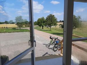 a window with two bikes parked on a road at Munkagården Bed & Breakfast in Svalöv