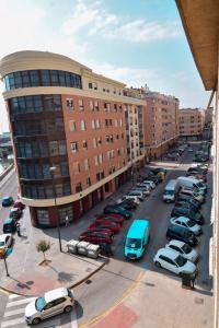 a parking lot with cars parked in front of a building at Letmalaga River Views in Málaga