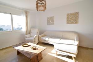 a living room with a couch and a coffee table at Letmalaga River Views in Málaga