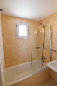 a bathroom with a shower and a tub and a sink at Letmalaga River Views in Málaga