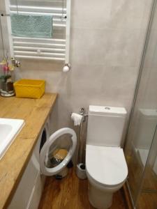 a bathroom with a white toilet and a sink at Oksywski bulwar in Gdynia