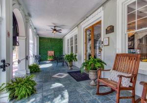 a porch with a rocking chair and plants at New Hotel Collection Downtown St Pete in St Petersburg