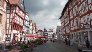 a city street with buildings and tables and chairs at Haus Luise in Homberg