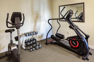 a gym with two exercise bikes and a mirror at Affordable Suites Mooresville in Mooresville