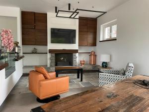 a living room with a table and a fireplace at Alba Relais in Nemoli
