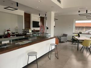 a kitchen with a counter and chairs and a table at Alba Relais in Nemoli