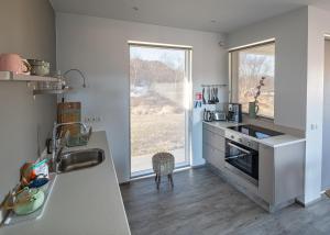 a kitchen with a sink and a stove top oven at Mývatn apartments in Myvatn