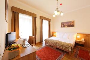 Postel nebo postele na pokoji v ubytování Hotel Historia & Historante