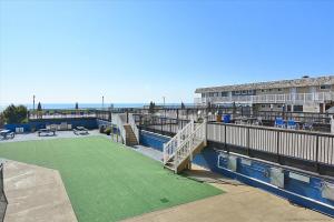 a building with a tennis court next to the ocean at Fountainhead Towers in Ocean City