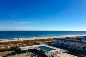 a building with a swimming pool next to the beach at Fountainhead Towers in Ocean City